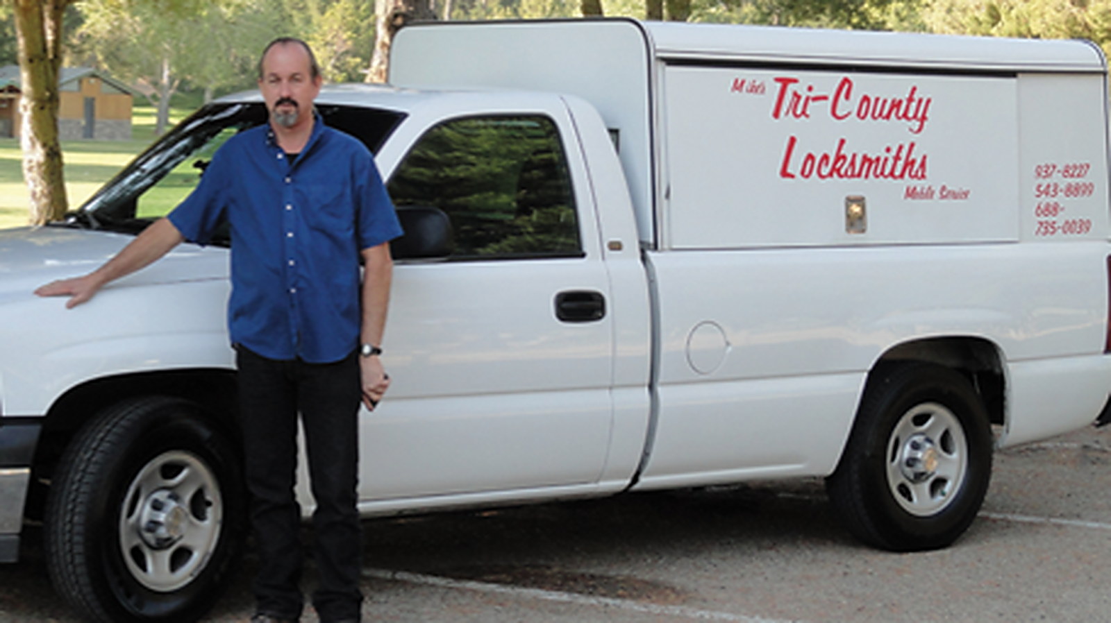 Michael Head beside his service truck lettered Mike's Tri-County Locksmiths